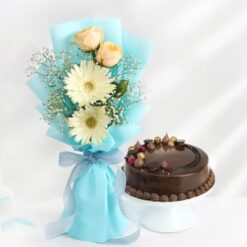 Elegant floral bouquet with a delicious cake, creating a perfect gift for birthdays, anniversaries, and special occasions.