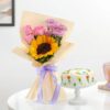 Sunflowers and roses beautifully arranged with a delectable cake, creating the perfect surprise gift for any joyful celebration.