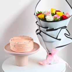 A luxurious floral arrangement paired with a delicious cake, perfect for adding elegance and sweetness to any occasion.