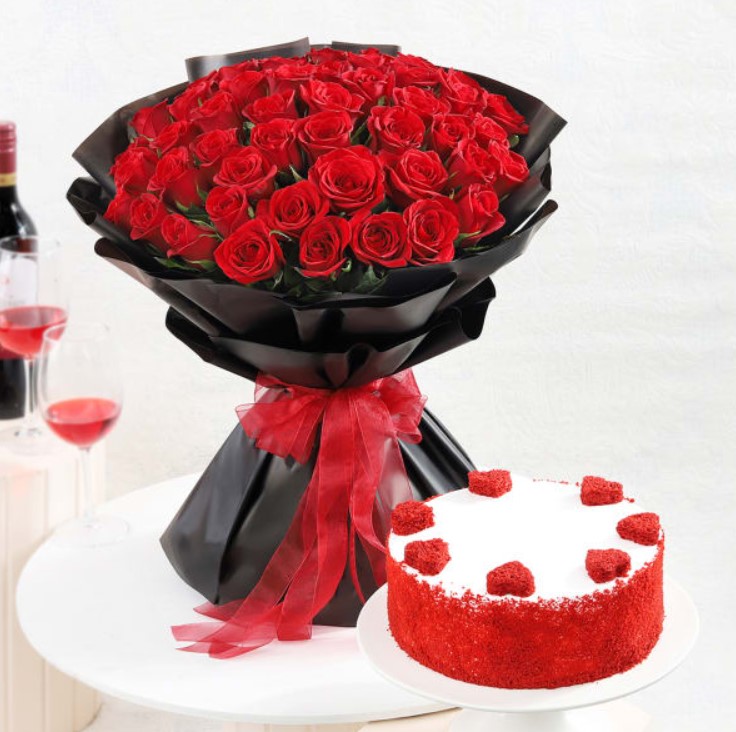 Rosy Glow With Red Velvet Cake Rosy Velvet Indulgence featuring a rich velvet cake and elegant red roses, perfect for special occasions and romantic surprises.