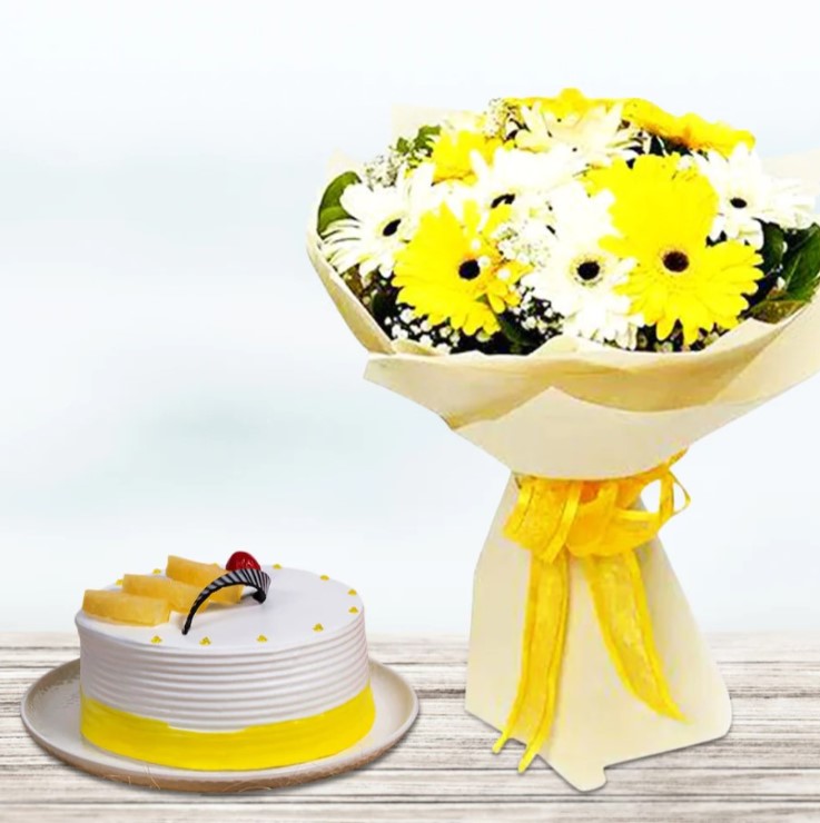Tropical Gerberas & Pineapple Delight Colorful tropical flowers with a delectable cake, a perfect gift combo for birthdays, anniversaries, and special celebrations.